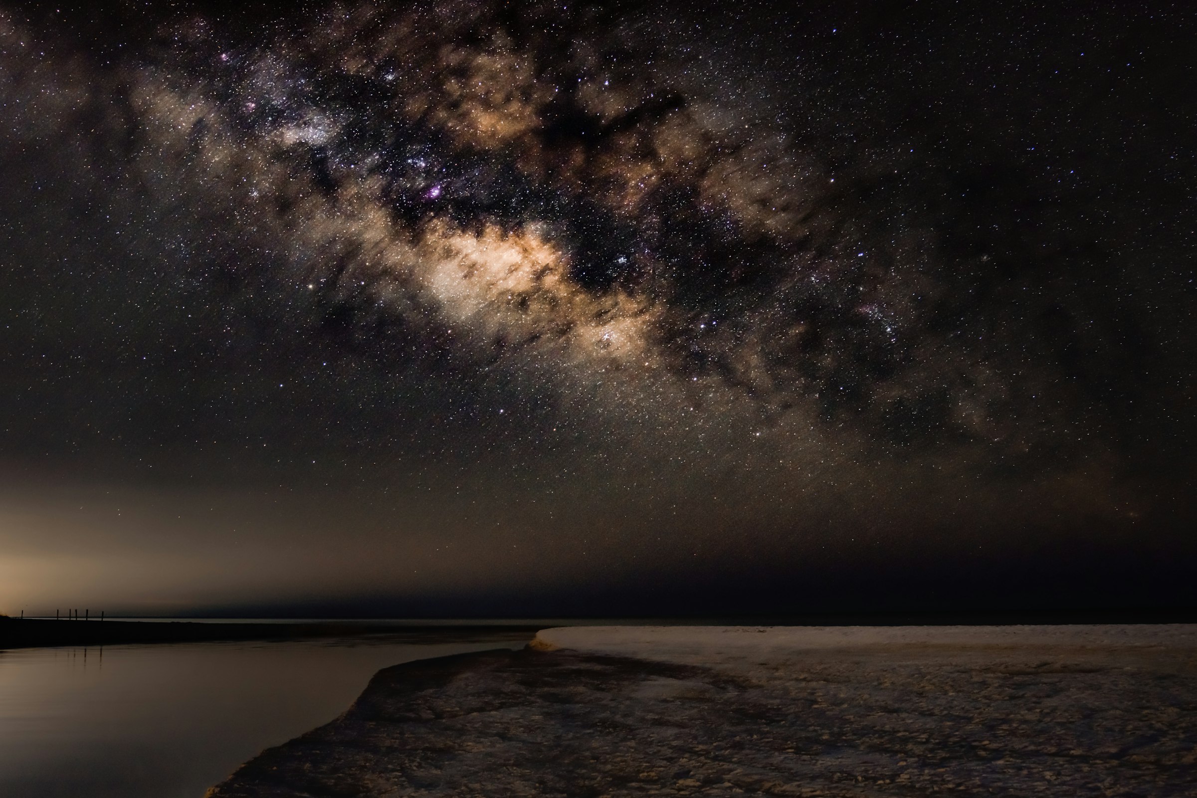 The Milky Way over a calm landscape, suggesting interconnected systems running at scale